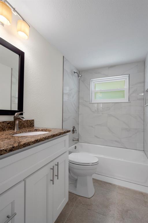 4315 Flexer Drive Hernando Beach, FL 34607 - Photo 8 of 48 a bathroom with a granite countertop sink a toilet and a bathtub