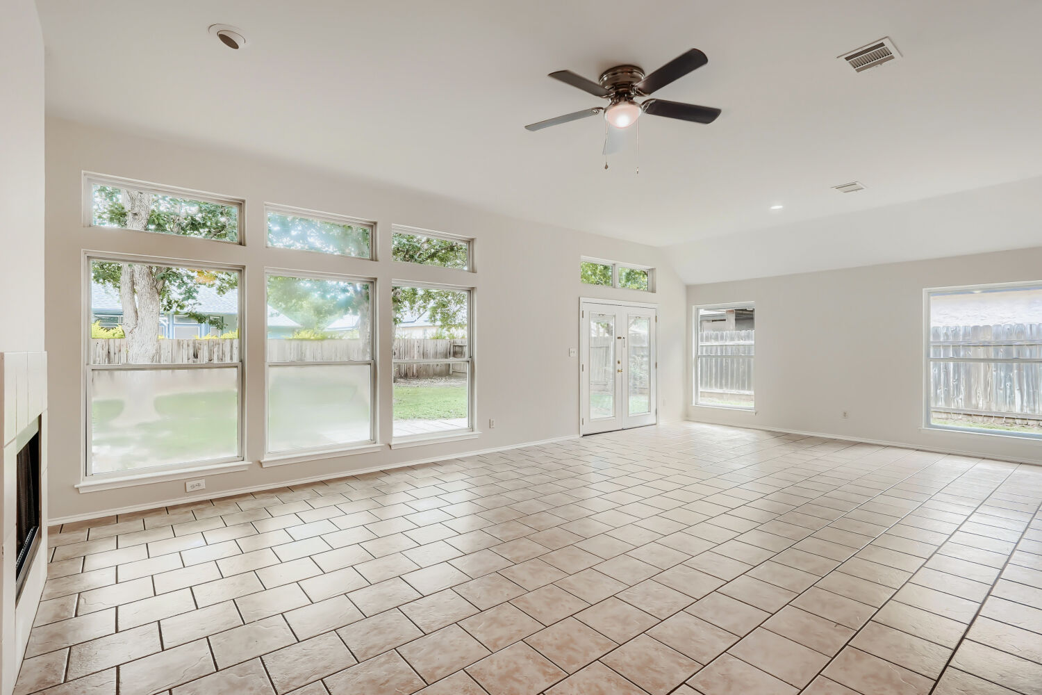 119 Stephen Lane Georgetown, TX 78626 - Photo 3 of 32 A bright spacious living area features floor to ceiling windows, including transom windows, durable tiled flooring and abundant natural leading to the private yard shaded by 5 beautiful mature trees.