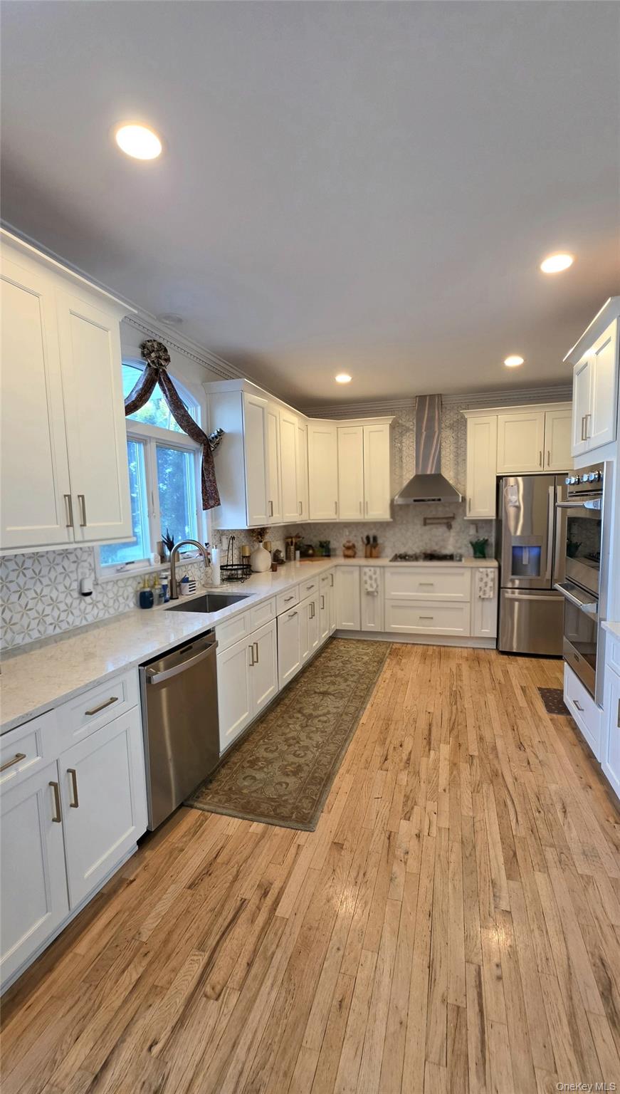 185 West Islip Road West Islip, NY 11795 - Photo 12 of 50 Kitchen with endless quartz countertop space and marble backsplash!