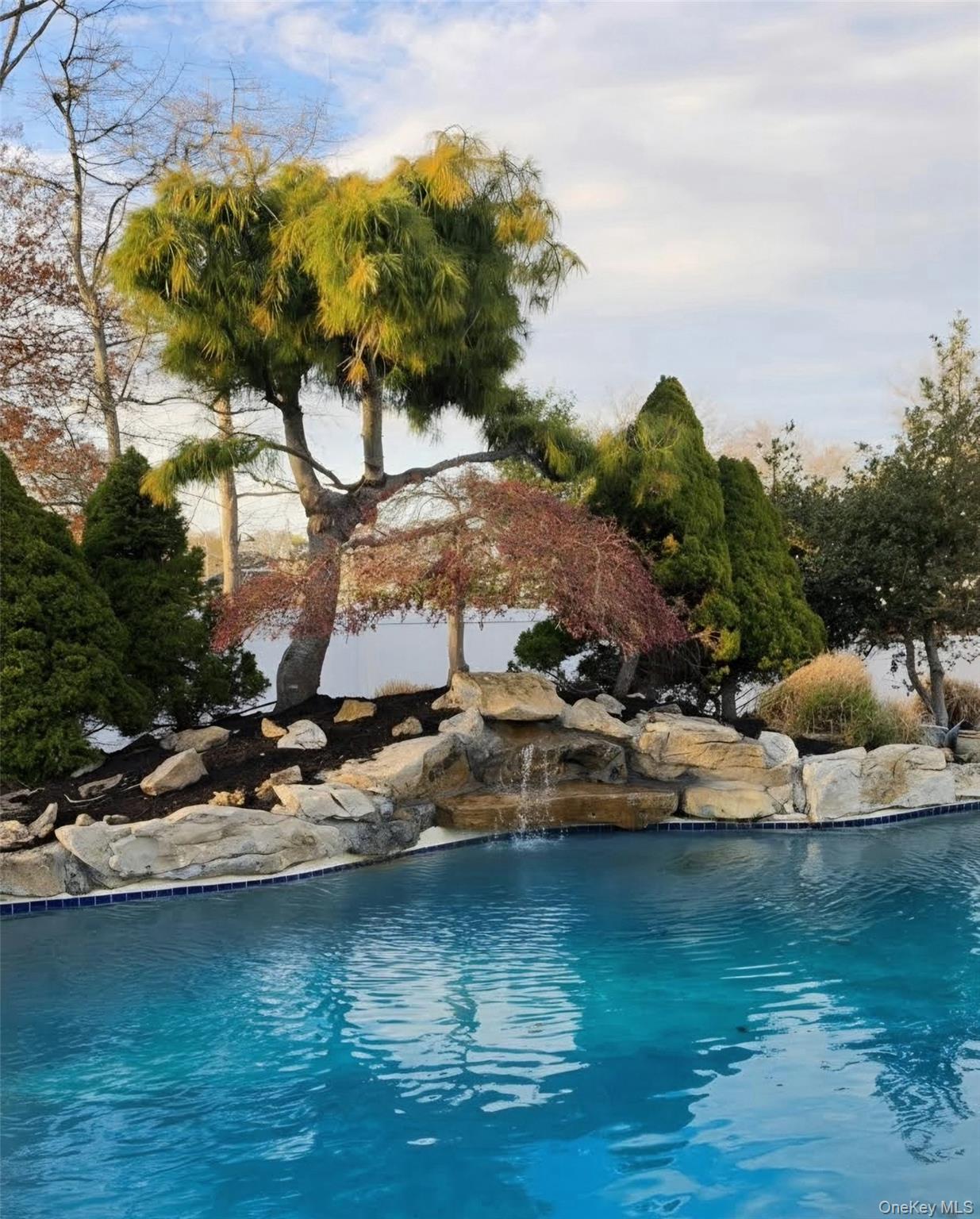 185 West Islip Road West Islip, NY 11795 - Photo 40 of 50 Serenity at last! Cascading waterfall into custom heated salt water pool!