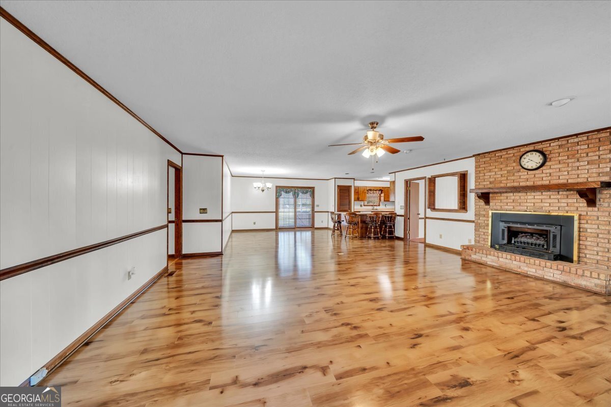 6501 Harley Trail Blackshear, GA 31516 - Photo 12 of 69 a view of an empty room with wooden floor fireplace and a window