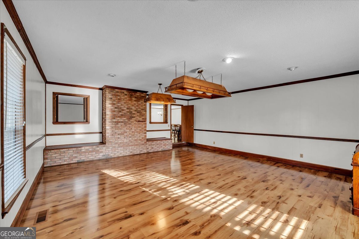 6501 Harley Trail Blackshear, GA 31516 - Photo 15 of 69 a view of an empty room with window and wooden floor