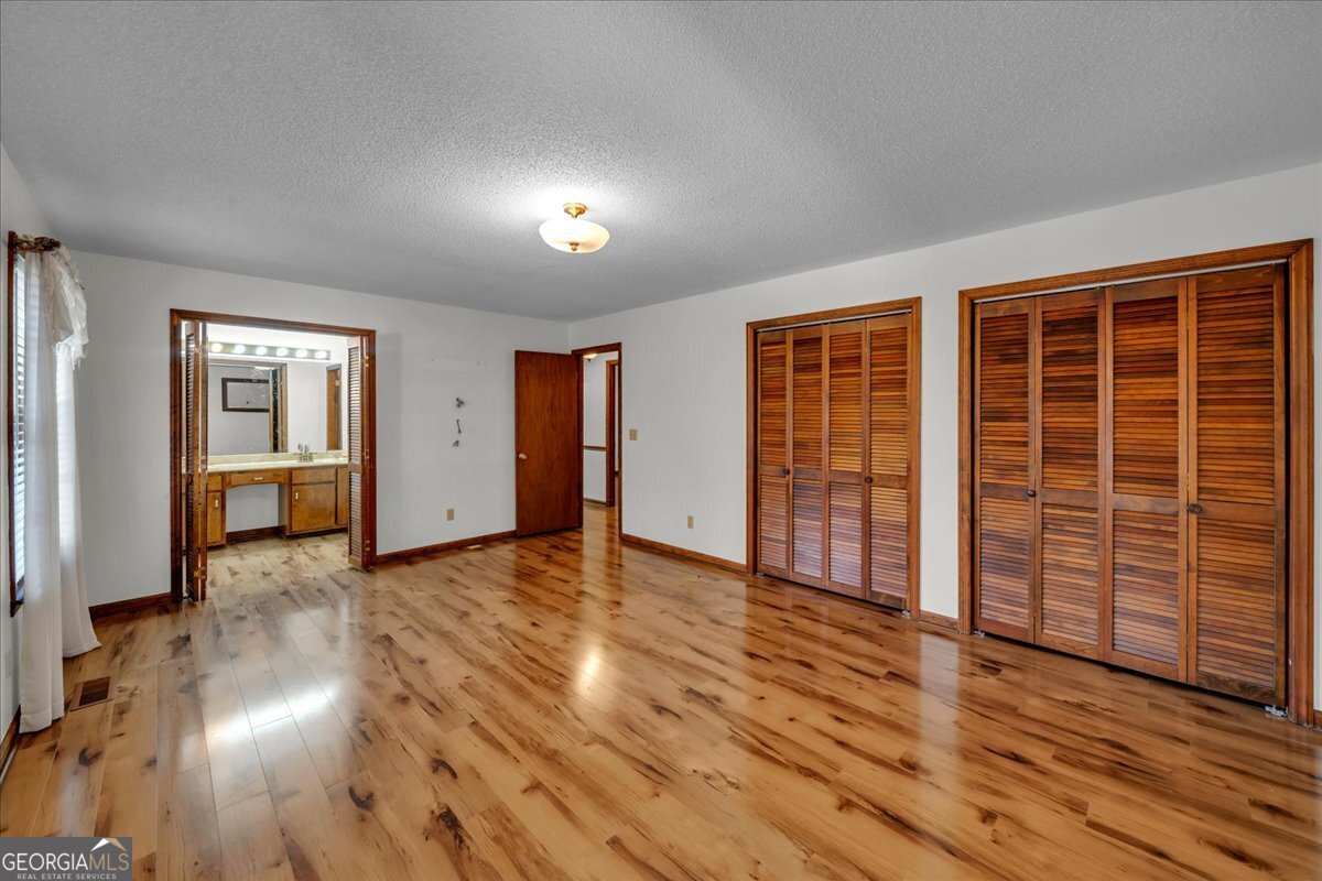6501 Harley Trail Blackshear, GA 31516 - Photo 21 of 69 an empty room with wooden floor and windows