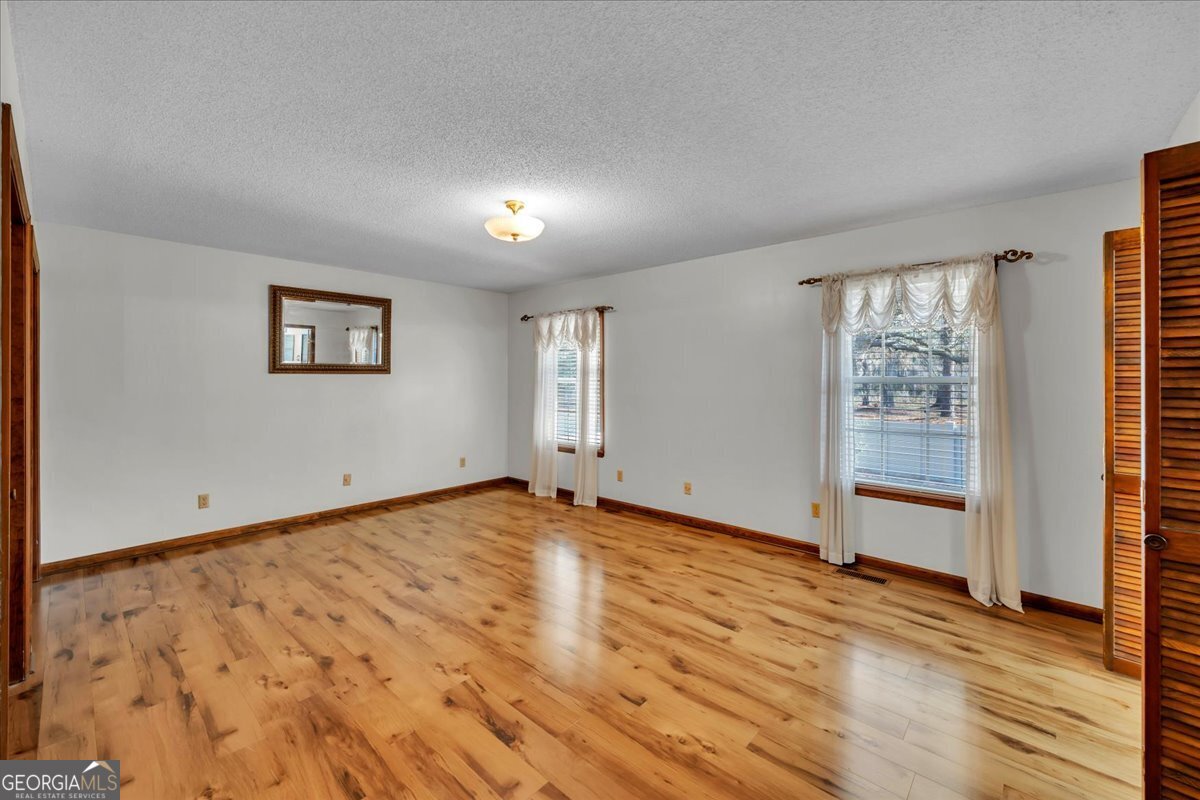 6501 Harley Trail Blackshear, GA 31516 - Photo 24 of 69 wooden floor in an empty room with a window