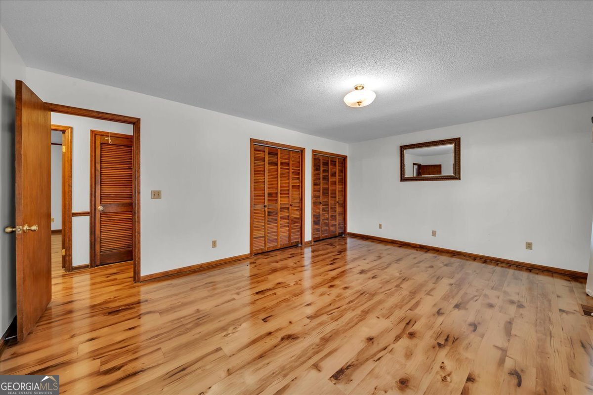 6501 Harley Trail Blackshear, GA 31516 - Photo 27 of 69 an empty room with wooden floor and windows