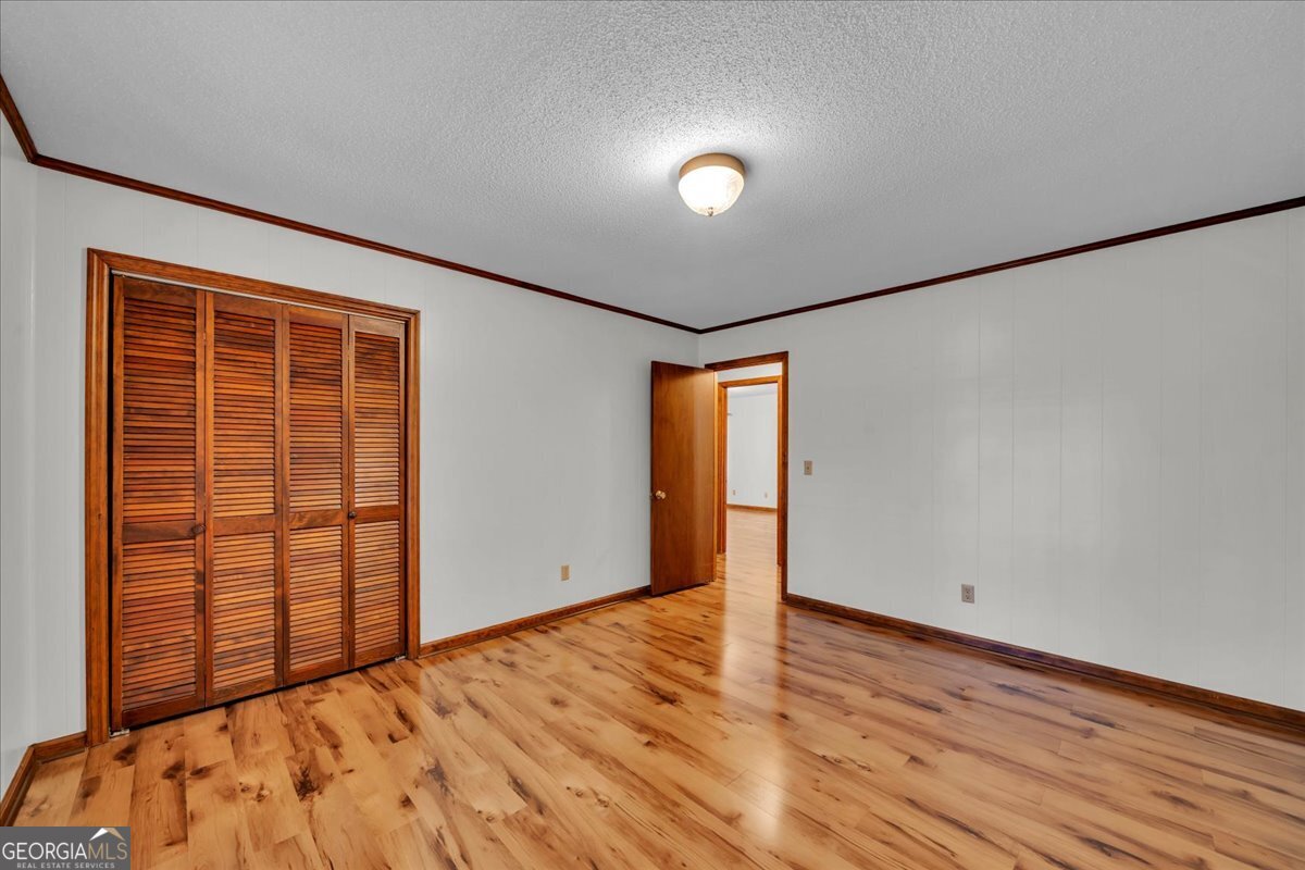 6501 Harley Trail Blackshear, GA 31516 - Photo 30 of 69 an empty room with wooden floor and windows