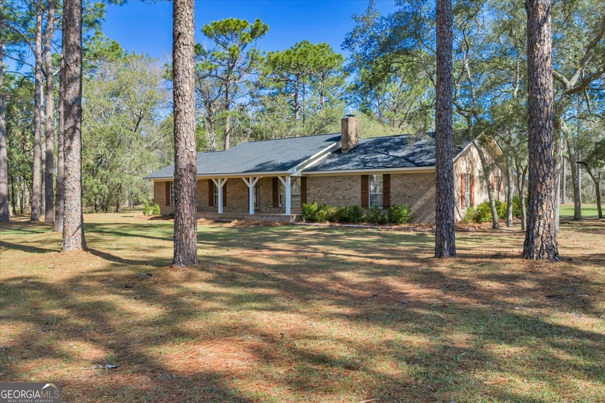 6501 Harley Trail Blackshear, GA 31516 - Photo 3 of 69 a front view of a house with a garden
