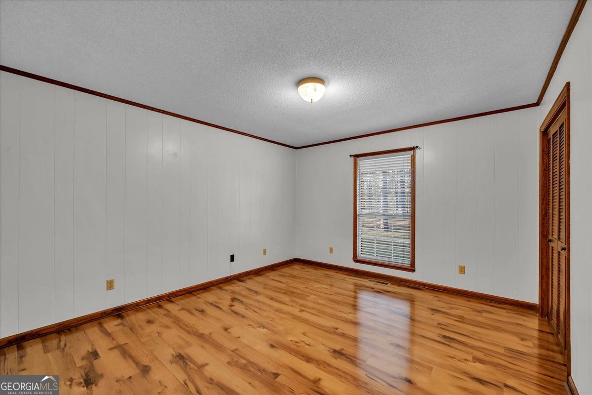6501 Harley Trail Blackshear, GA 31516 - Photo 31 of 69 a view of empty room with wooden floor and fan