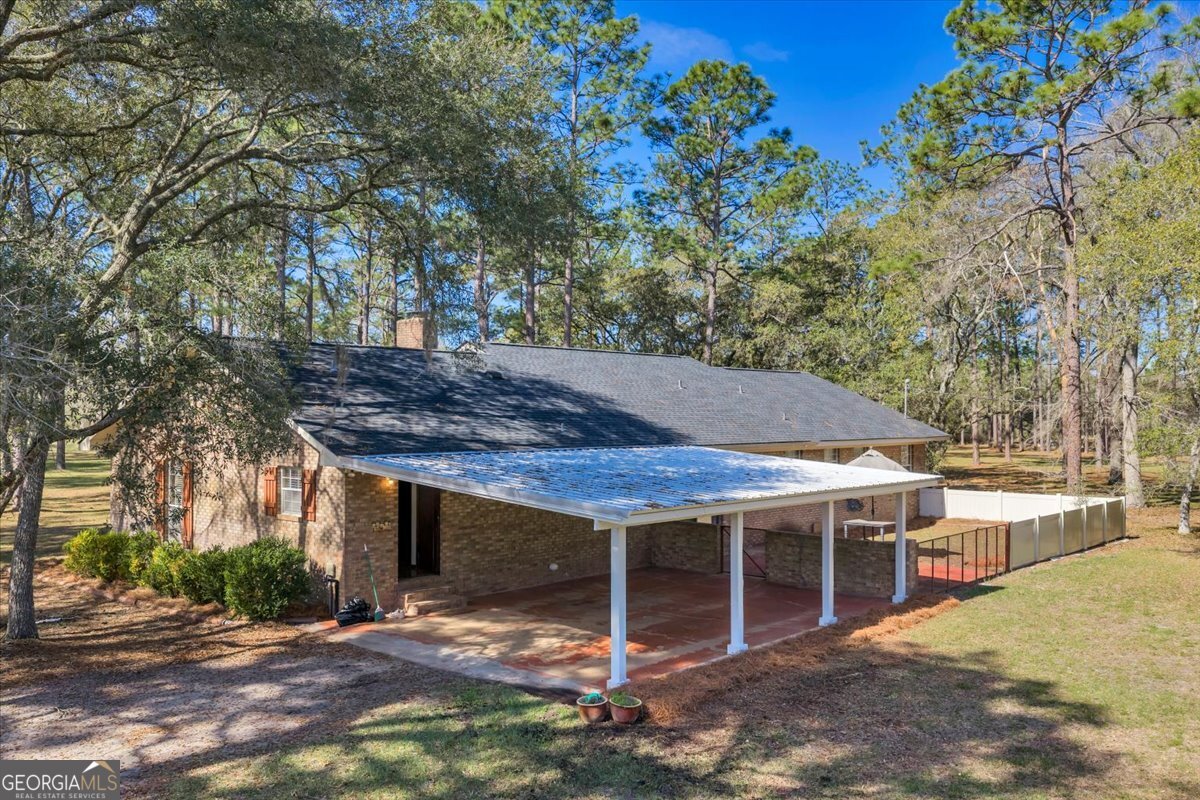 6501 Harley Trail Blackshear, GA 31516 - Photo 5 of 69 a backyard of a house with barbeque oven and large tree