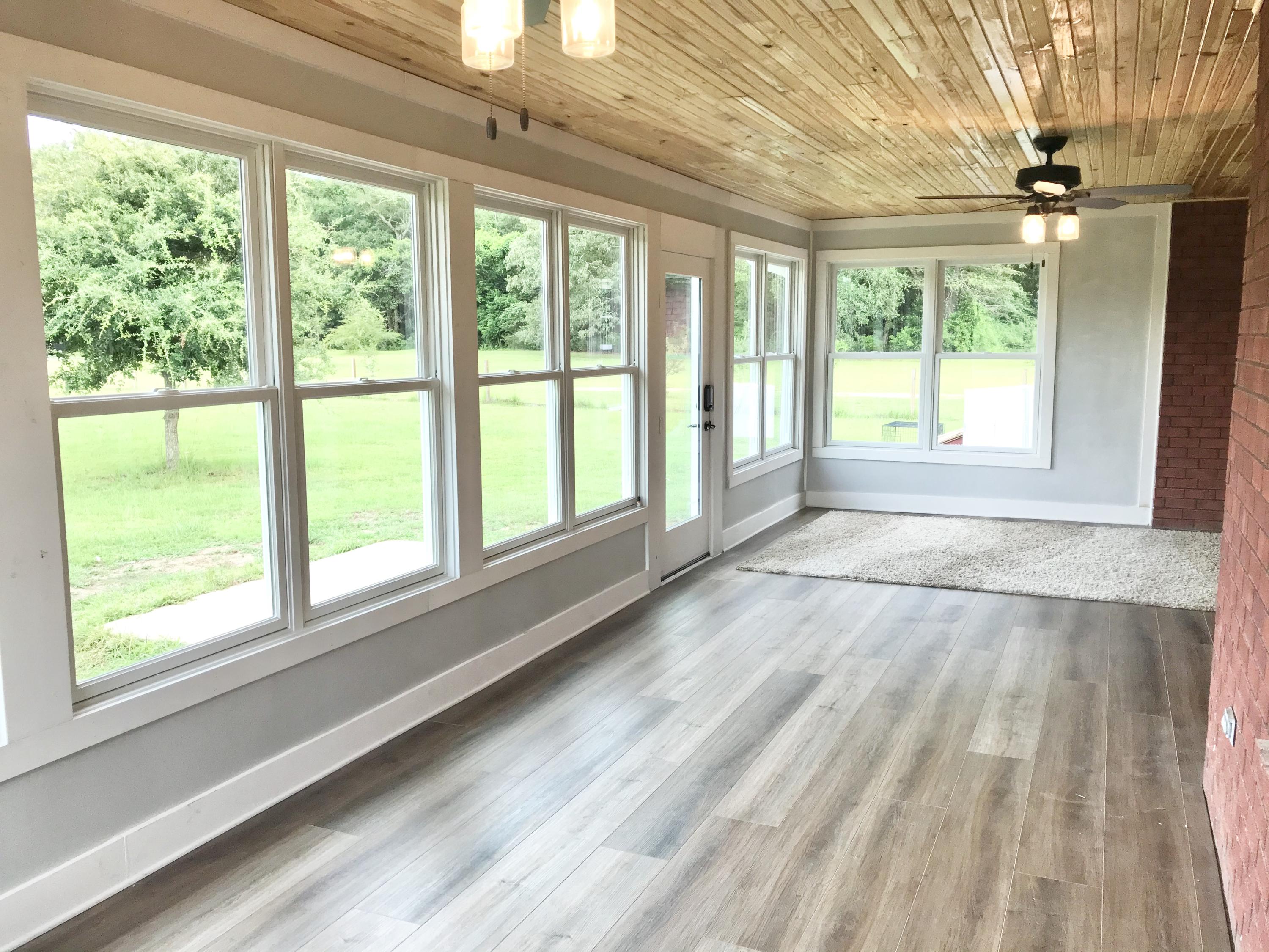 6593 Old River Road Baker, FL 32531 - Photo 13 of 23 a view of an empty room with wooden floor and a window