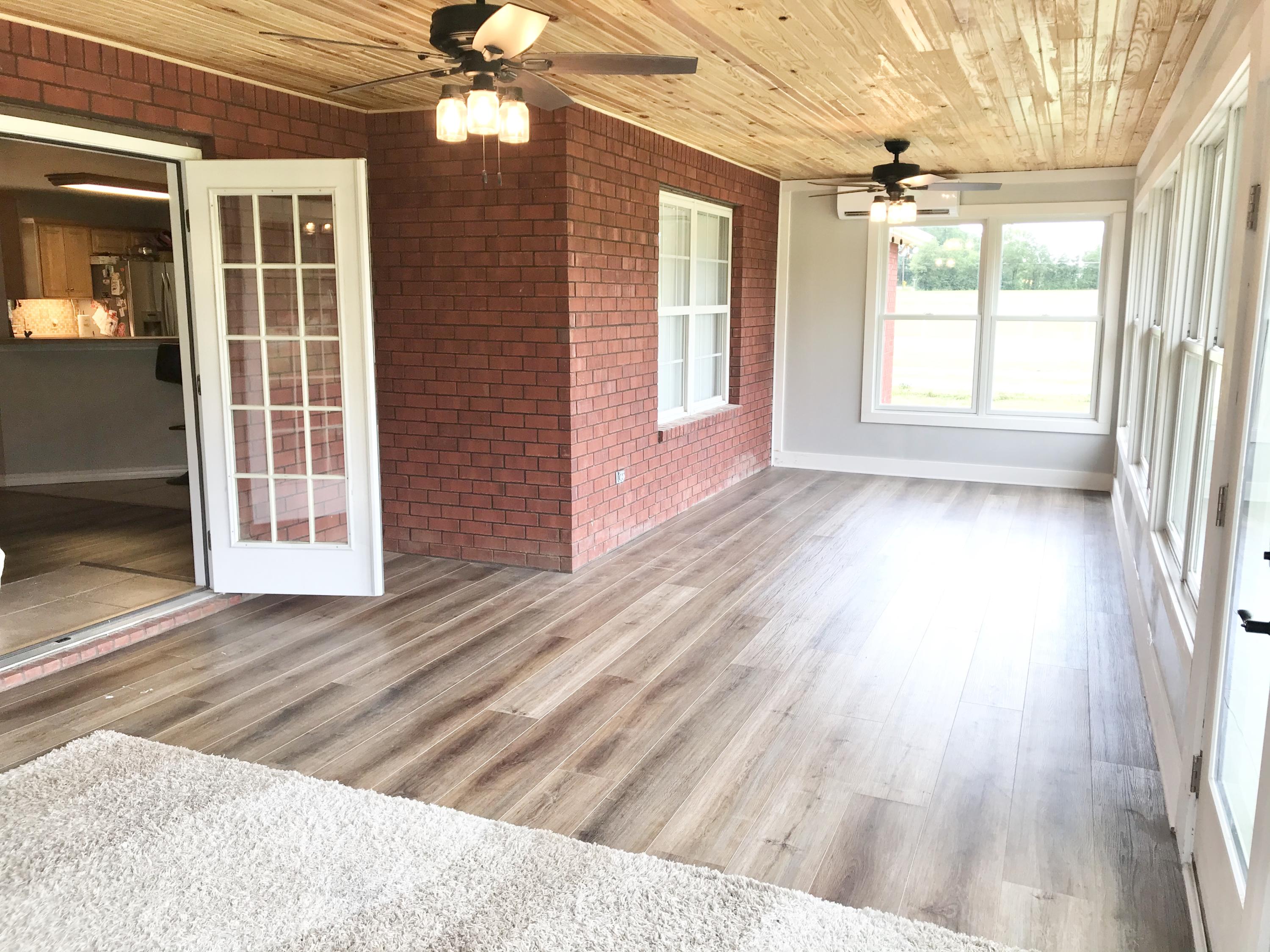 6593 Old River Road Baker, FL 32531 - Photo 14 of 23 a view of an empty room with wooden floor and a window