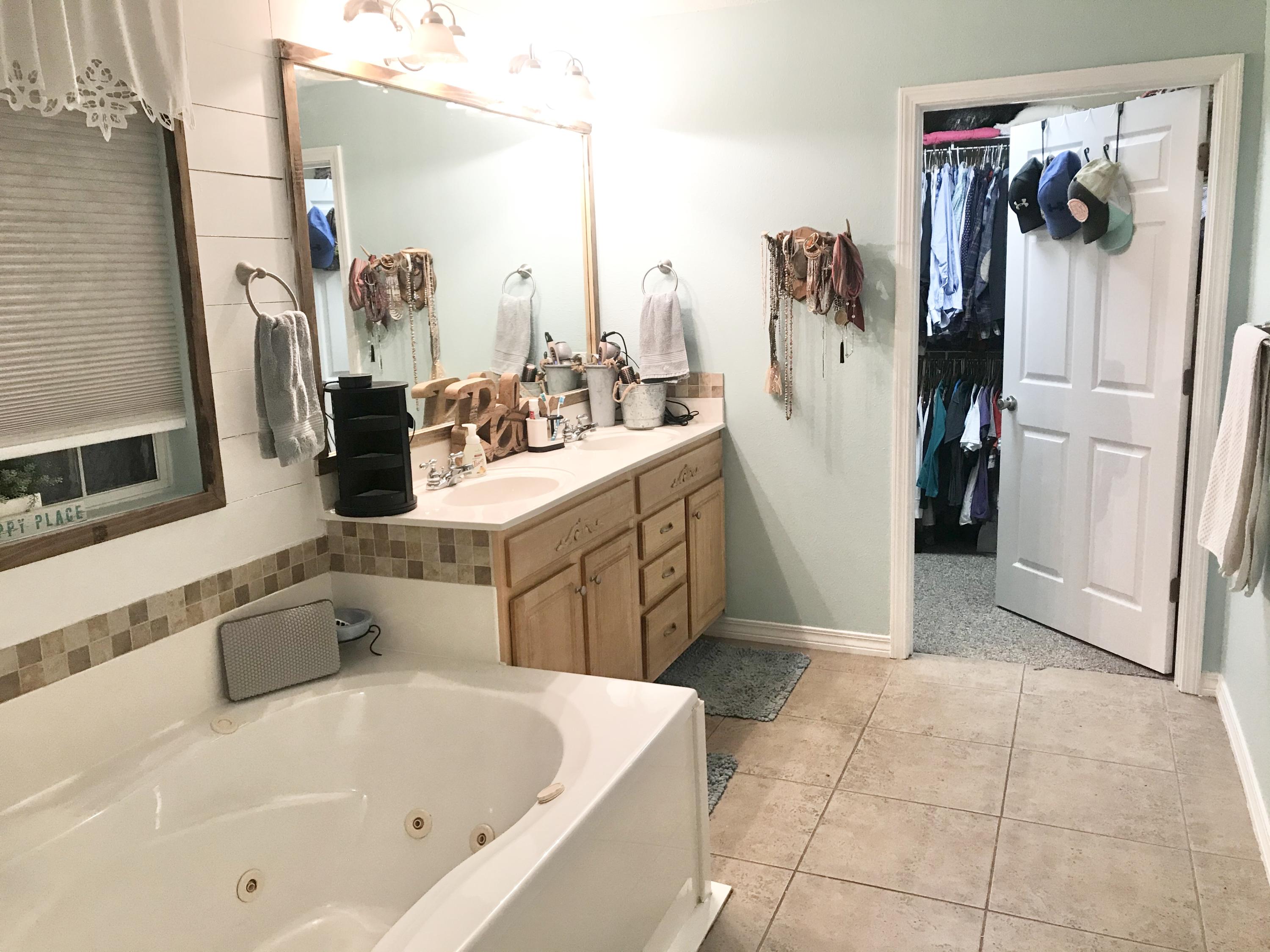 6593 Old River Road Baker, FL 32531 - Photo 18 of 23 a bathroom with a tub sink and a mirror