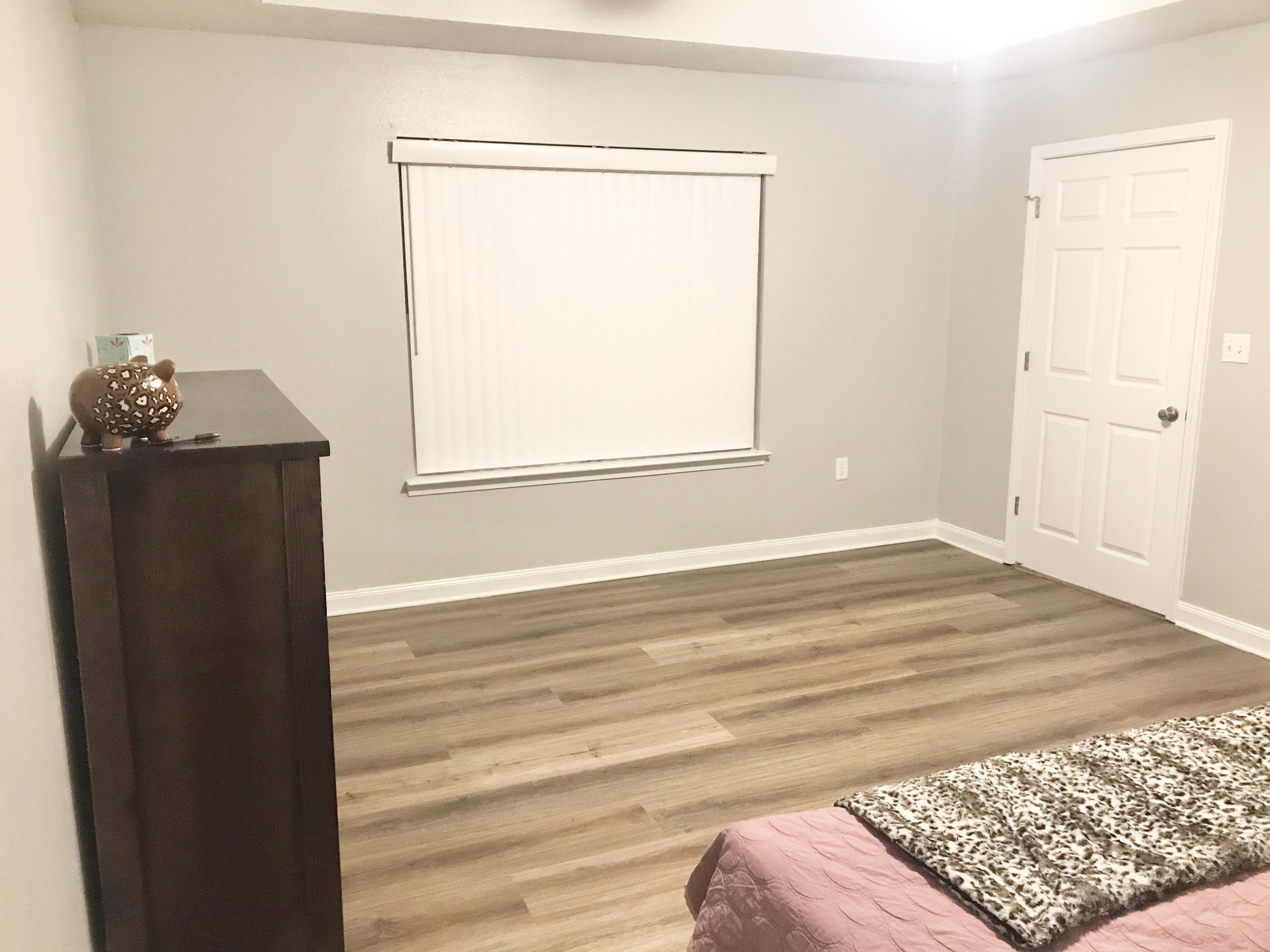 6593 Old River Road Baker, FL 32531 - Photo 22 of 23 a view of a bedroom with wooden floor and a window