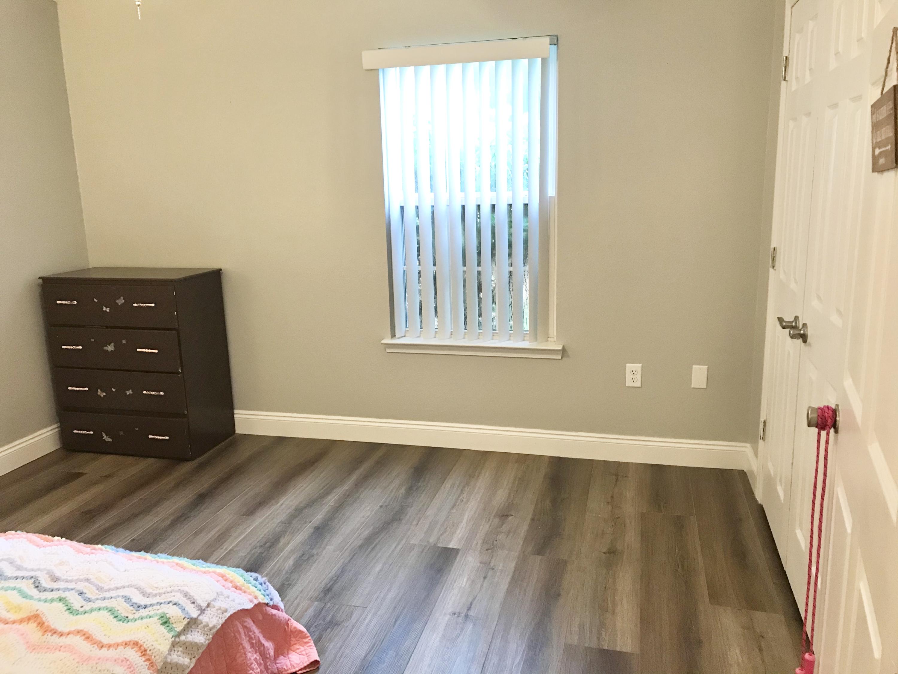 6593 Old River Road Baker, FL 32531 - Photo 4 of 23 wooden floor in a bedroom next to a window