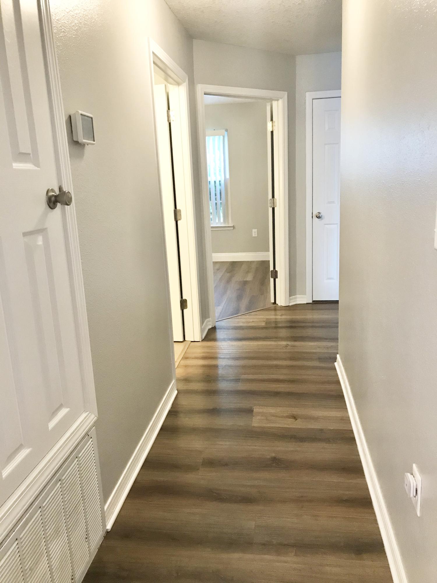 6593 Old River Road Baker, FL 32531 - Photo 9 of 23 a view of a hallway with wooden floor and staircase