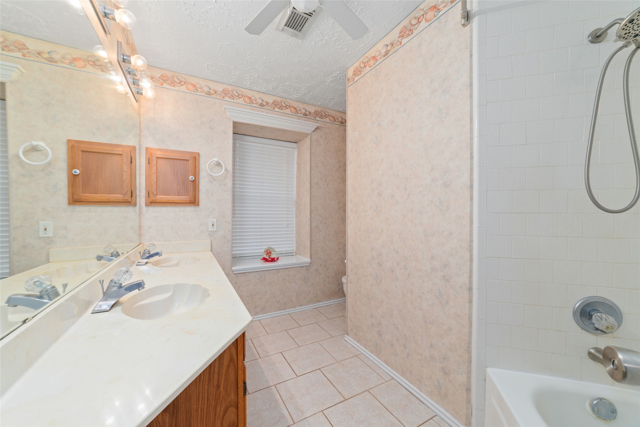 3315 Haydee Road Spring, TX 77388 - Photo 19 of 29 a bathroom with a sink a tub and a mirror