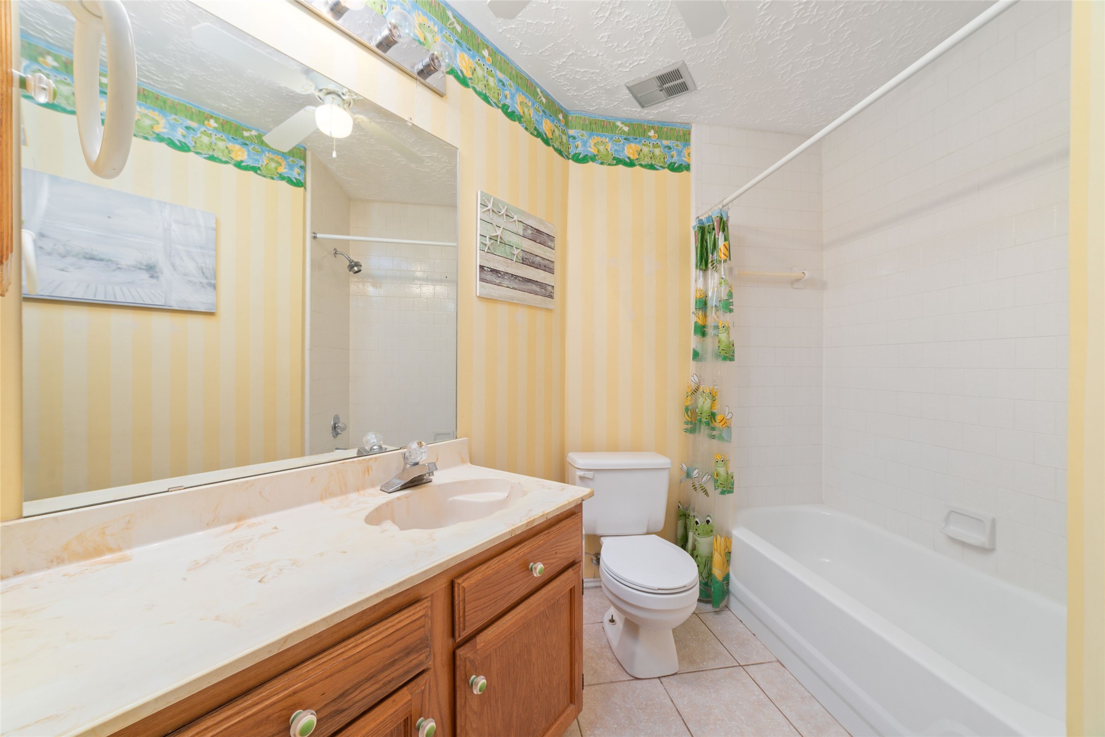 3315 Haydee Road Spring, TX 77388 - Photo 23 of 29 a bathroom with a granite countertop sink a toilet a mirror and bathtub