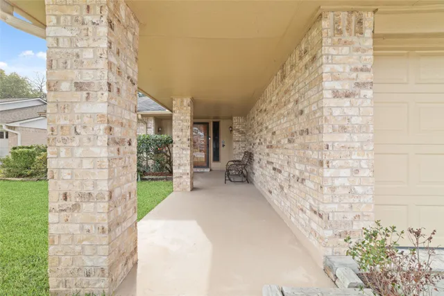 a view of entryway with wooden floor and front door