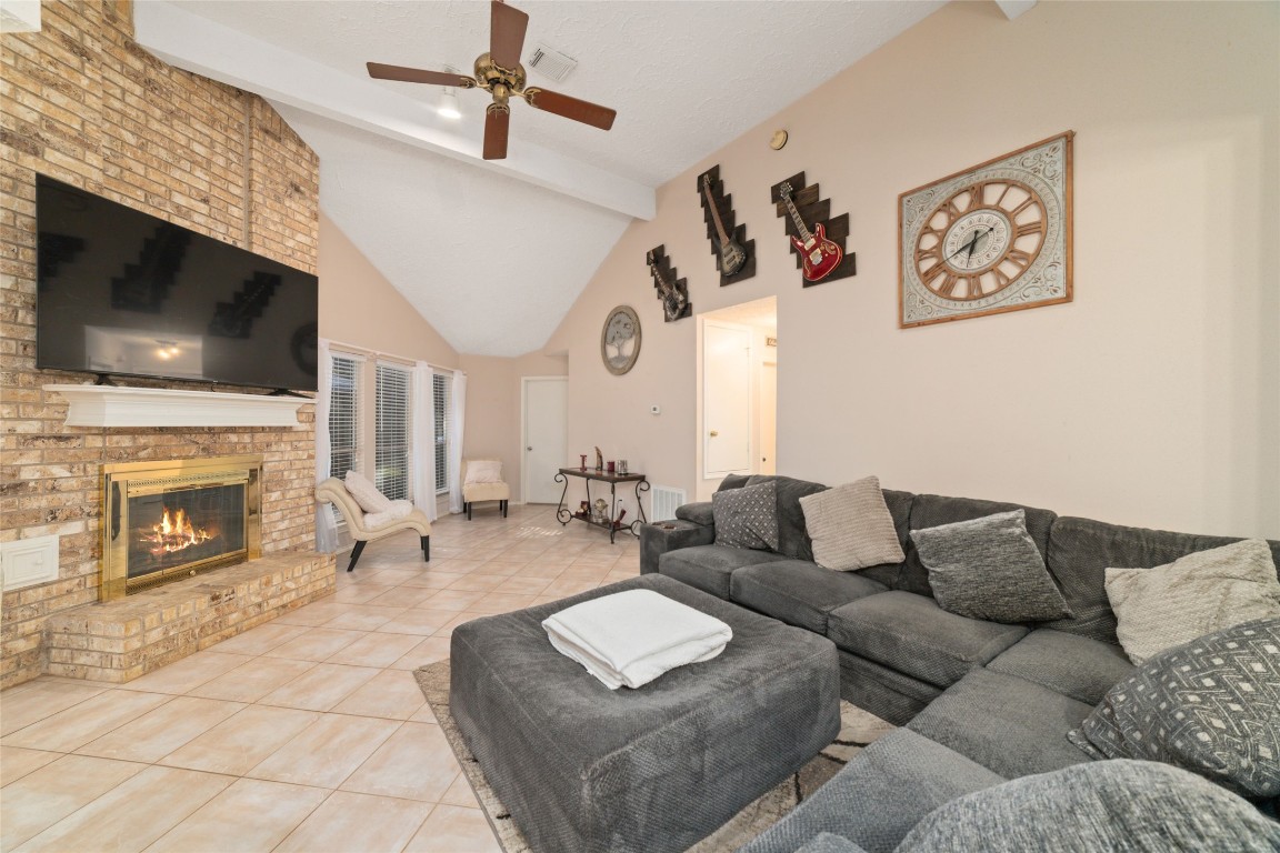 3315 Haydee Road Spring, TX 77388 - Photo 6 of 29 a living room with furniture a flat screen tv and a fireplace