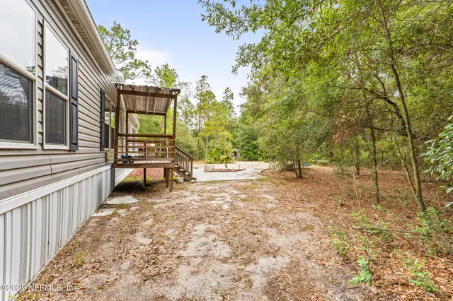 a view of a house with backyard and sitting area