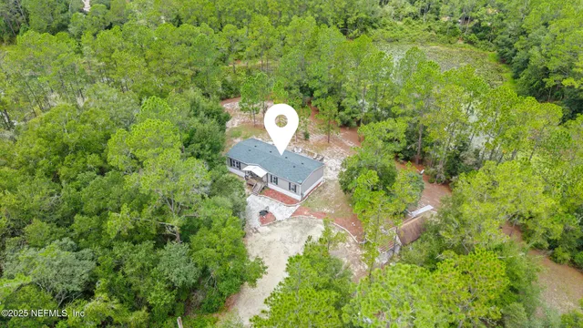 a aerial view of a house with a yard and garden