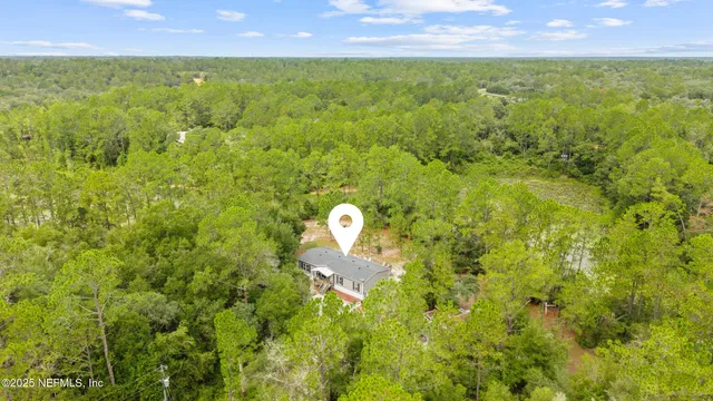 a aerial view of a houses with a yard