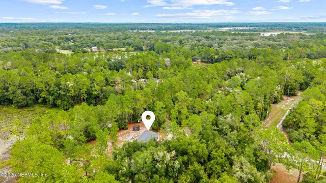 a view of a big yard with large trees