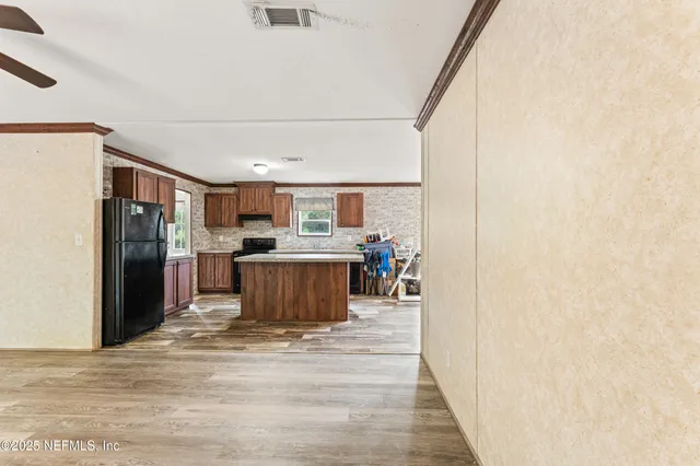 a view of a kitchen with wooden floor