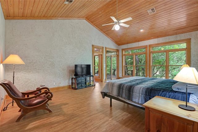 a bathroom with a granite countertop sink mirror and a bathtub
