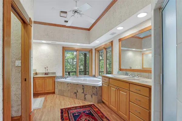 a large kitchen with a large window and stainless steel appliances
