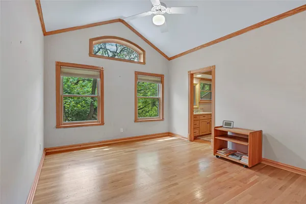 a bedroom with a bed and large windows