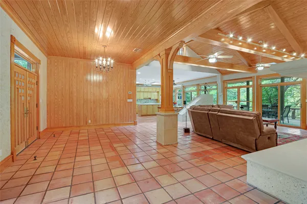 a living room with furniture a rug and a chandelier