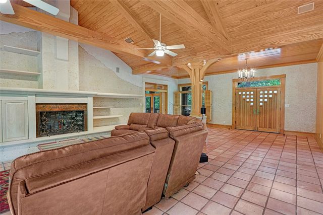 a view of a kitchen with a sink and large window
