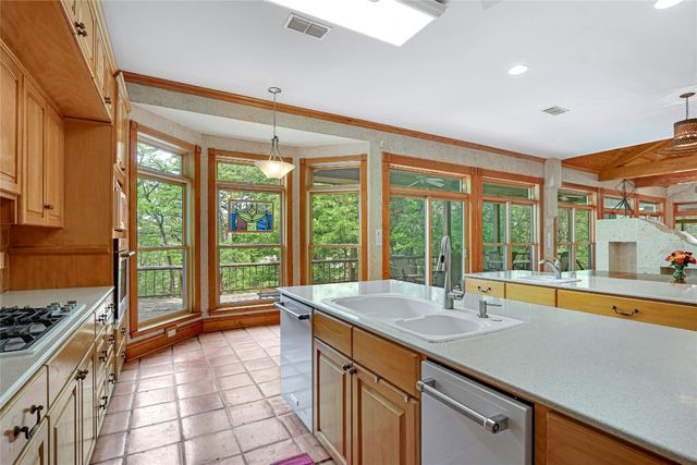 a large white kitchen with a large window