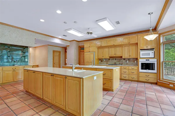 a kitchen with stainless steel appliances granite countertop a sink and cabinets