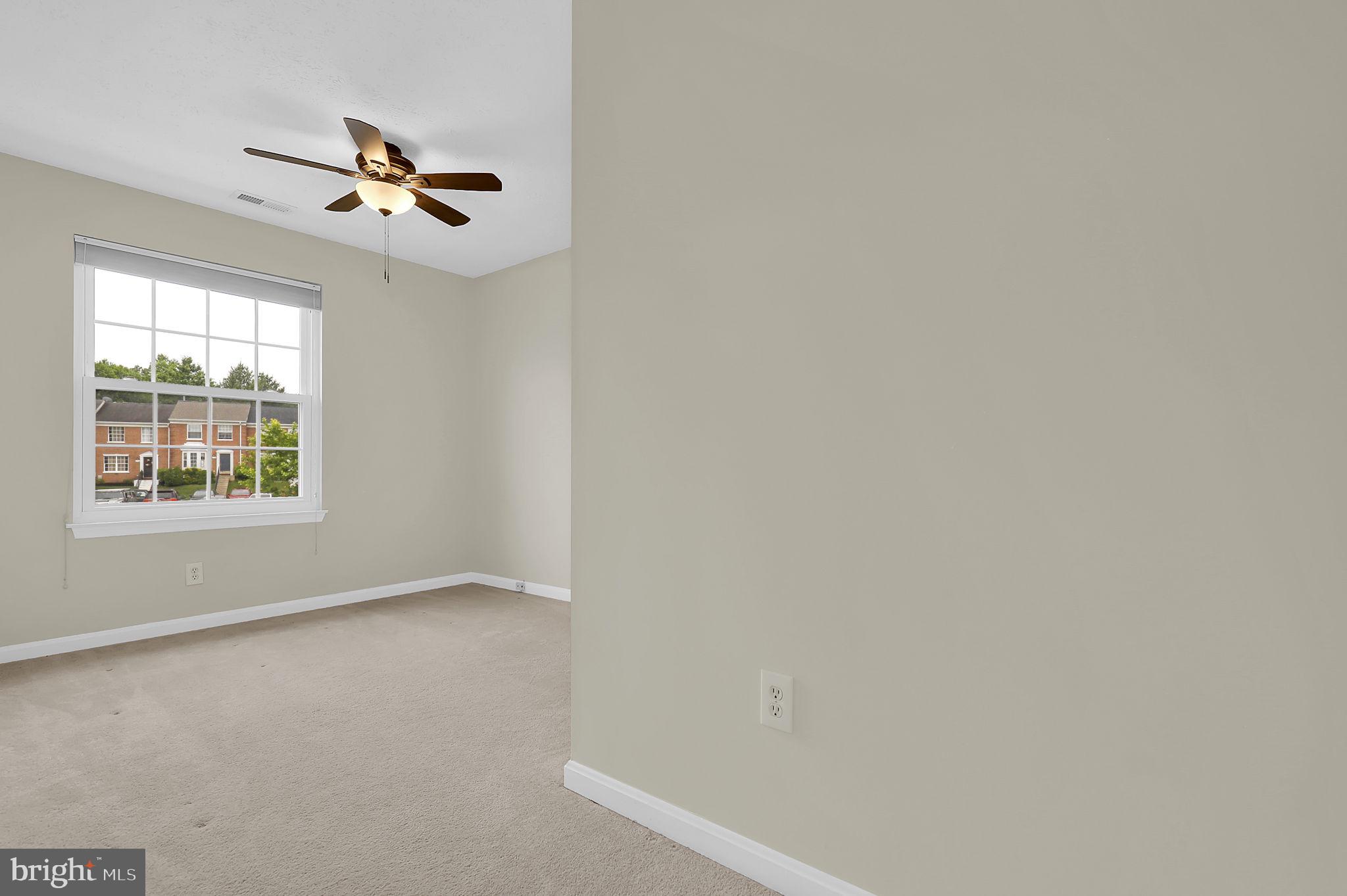 7150 Natures Road Columbia, MD 21046 - Photo 23 of 45 an empty room with windows and fan
