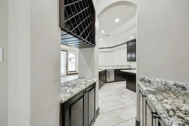 a view of a room with stainless steel appliances granite countertop furniture and a fireplace