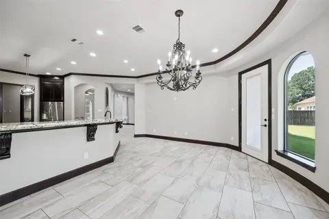 a view of a hallway with chandelier