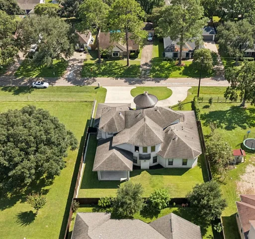 an aerial view of a house with a swimming pool