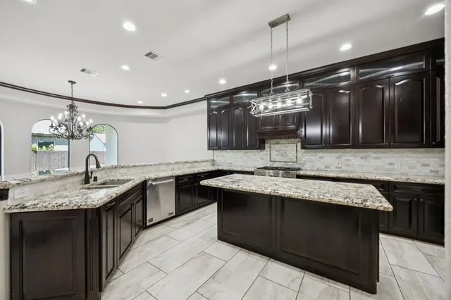 a bathroom with a granite countertop sink a mirror and shower