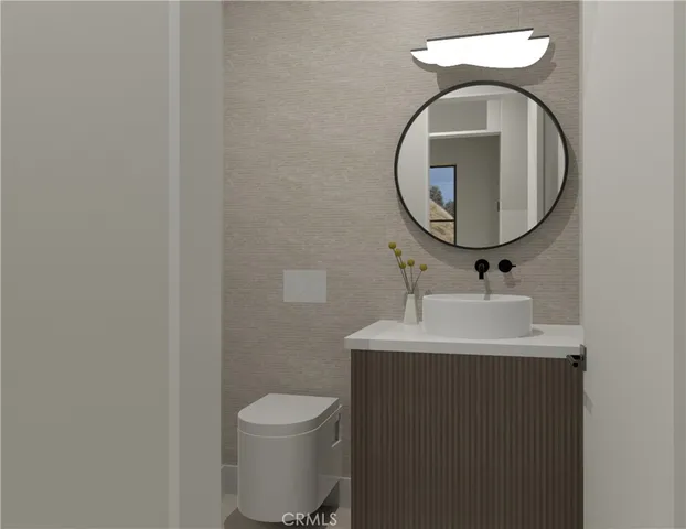 a bathroom with a toilet sink and mirror