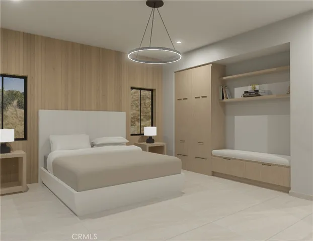 a bedroom with a large bed and a chandelier