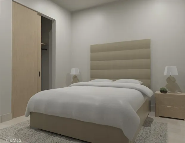 a bedroom with a bed and lamp