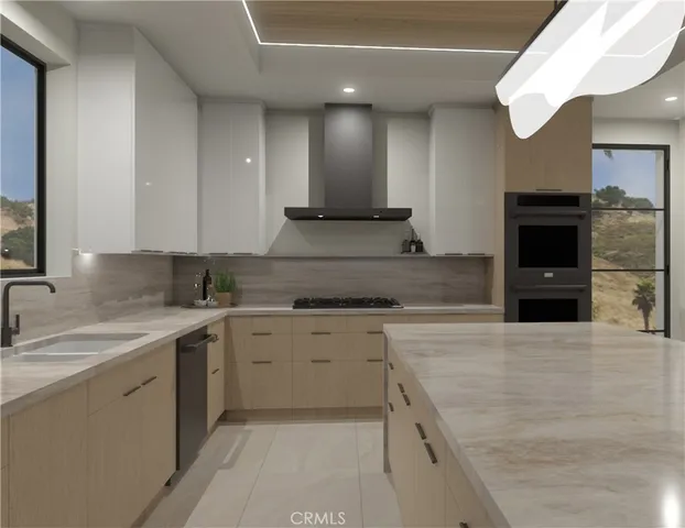 a kitchen with a sink and a stove top oven