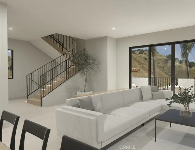 a living room with furniture and a potted plant