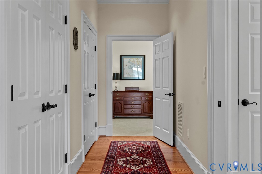 2515 Fleet's Bay Road White Stone, VA 22578 - Photo 29 of 74 a view of a hallway with a wooden floor and a bathroom