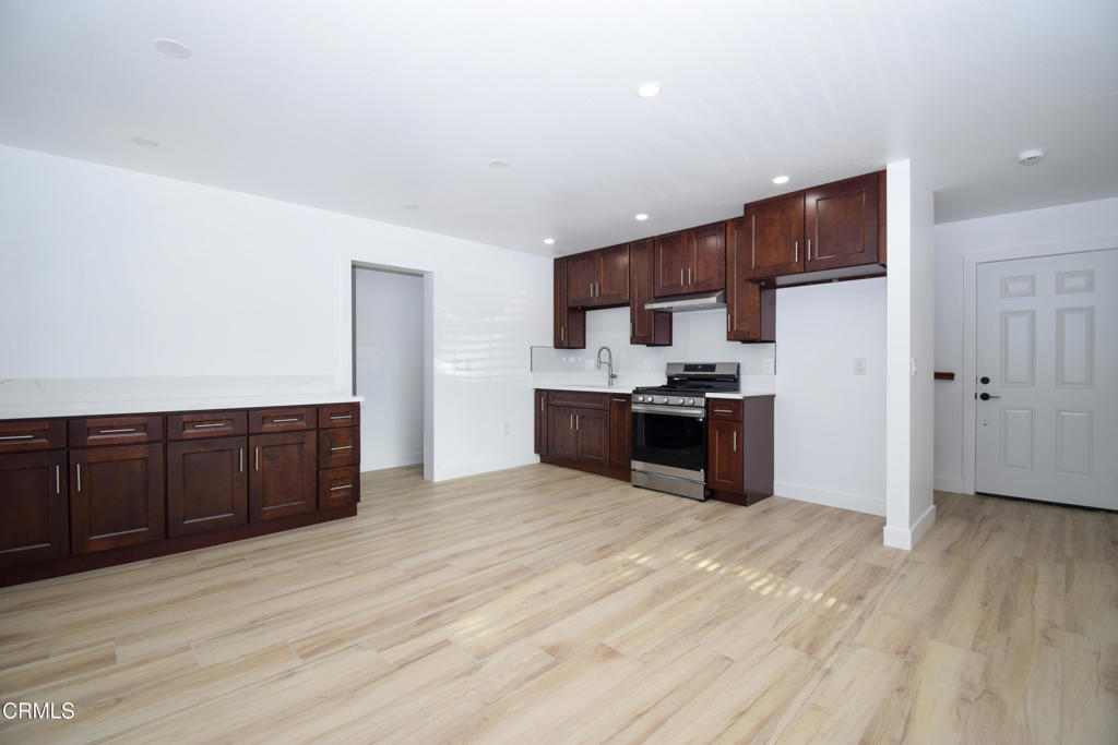 2711 Altus Way, Unit 2 Oxnard, CA 93035 - Photo 2 of 10 a kitchen with stainless steel appliances a refrigerator and wooden cabinets