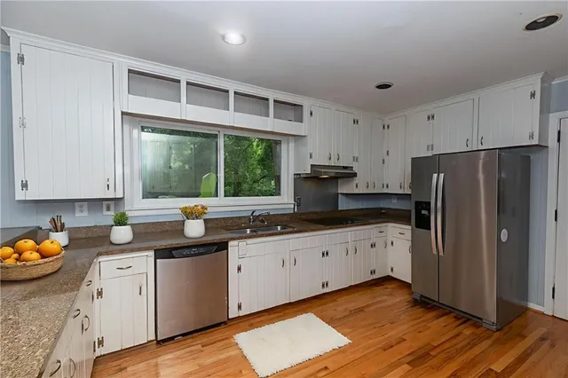 a view of an empty room with closet and a window