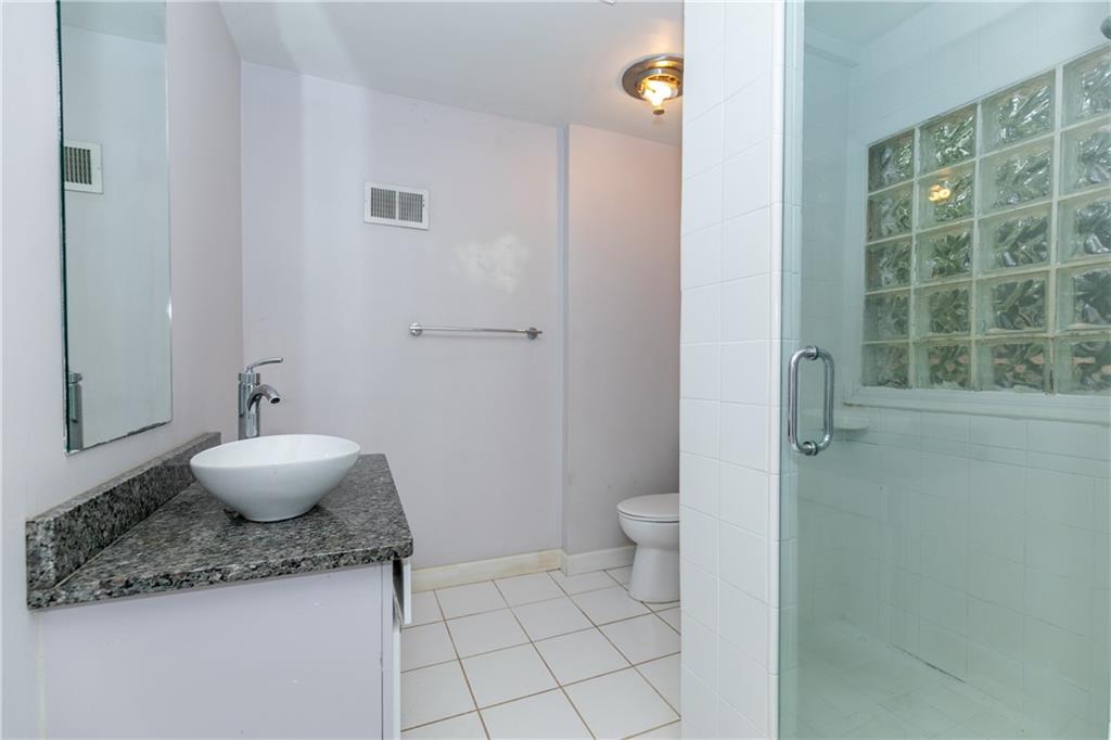 3175 Alton Road Atlanta, GA 30341 - Photo 34 of 76 a bathroom with a granite countertop sink a toilet and a mirror