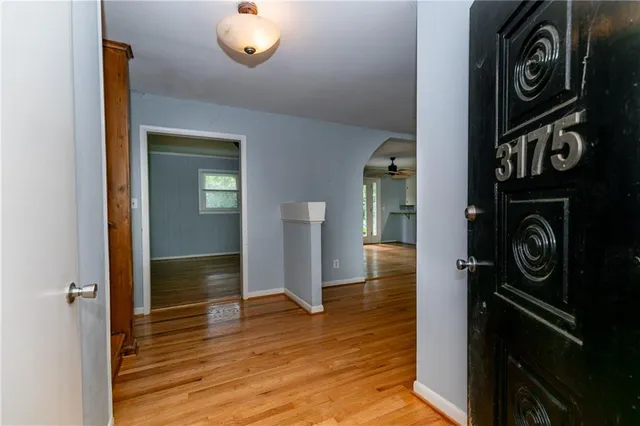 a bathroom with a granite countertop sink a toilet and a mirror